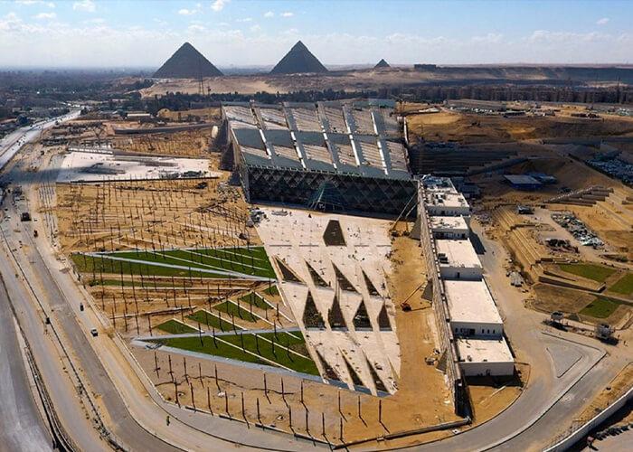 Grand Egyptian Museum building at Giza with the pyramids in the distance